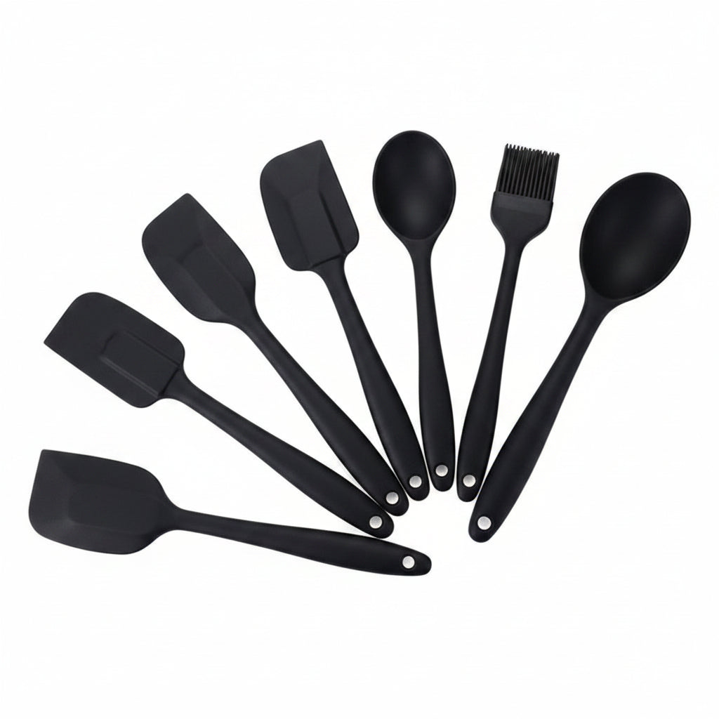 Set of black silicone kitchen utensils on a white background