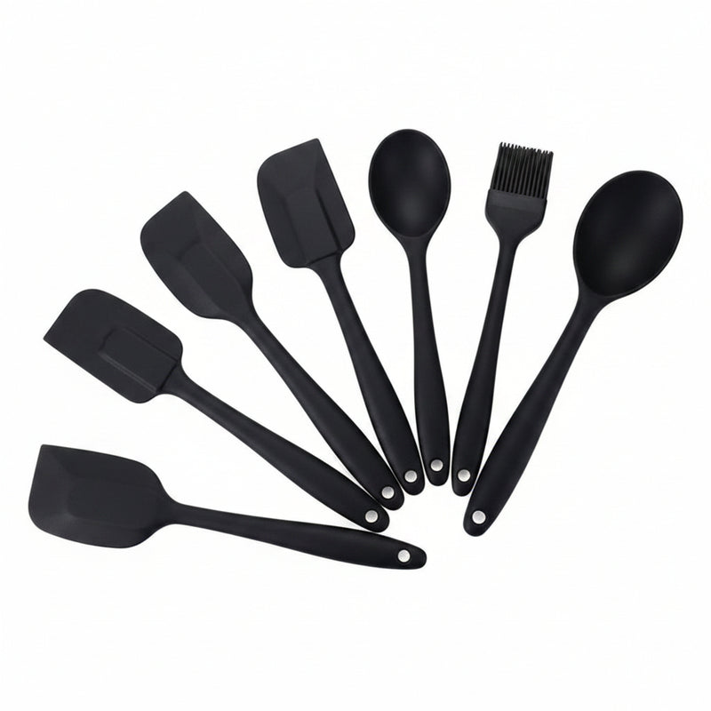 Set of black silicone kitchen utensils on a white background