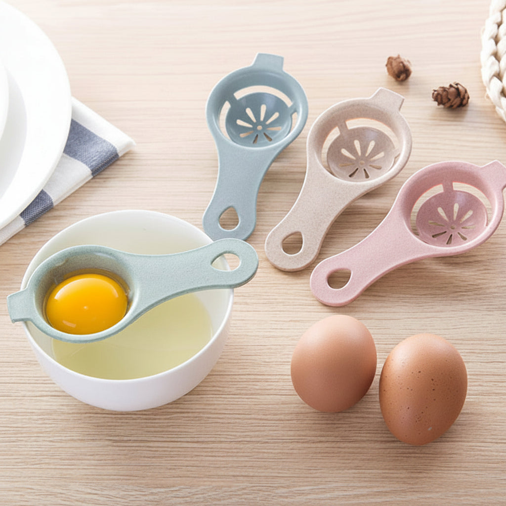 Three egg separators in blue, white, and pink on a wooden surface with eggs and a bowl.